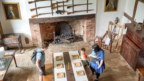 A family exploring inside the manor house at Brockhampton, Herefordshire